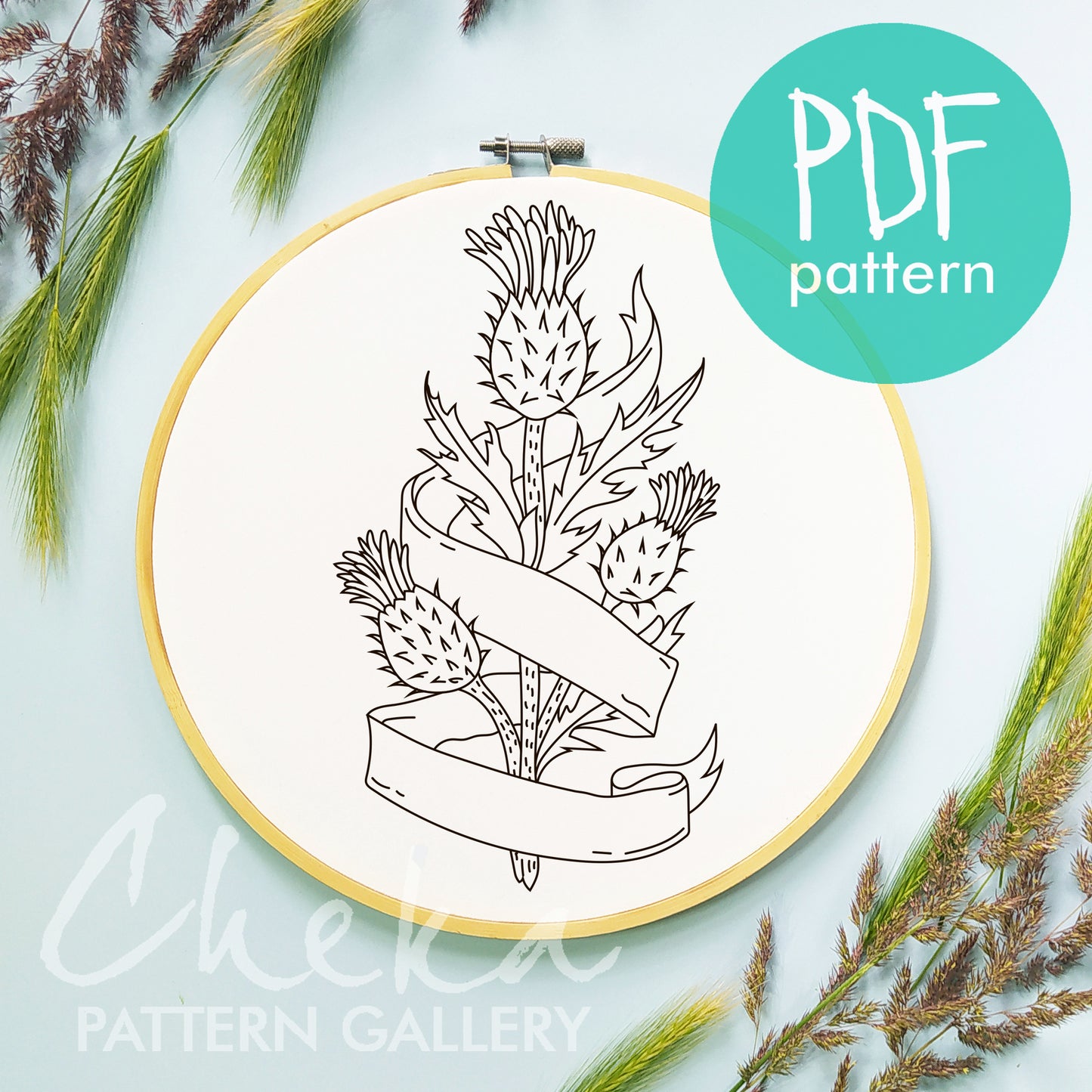 Embroidery hoop with a black and white thistle design and 'PDF pattern' label on a light blue background.