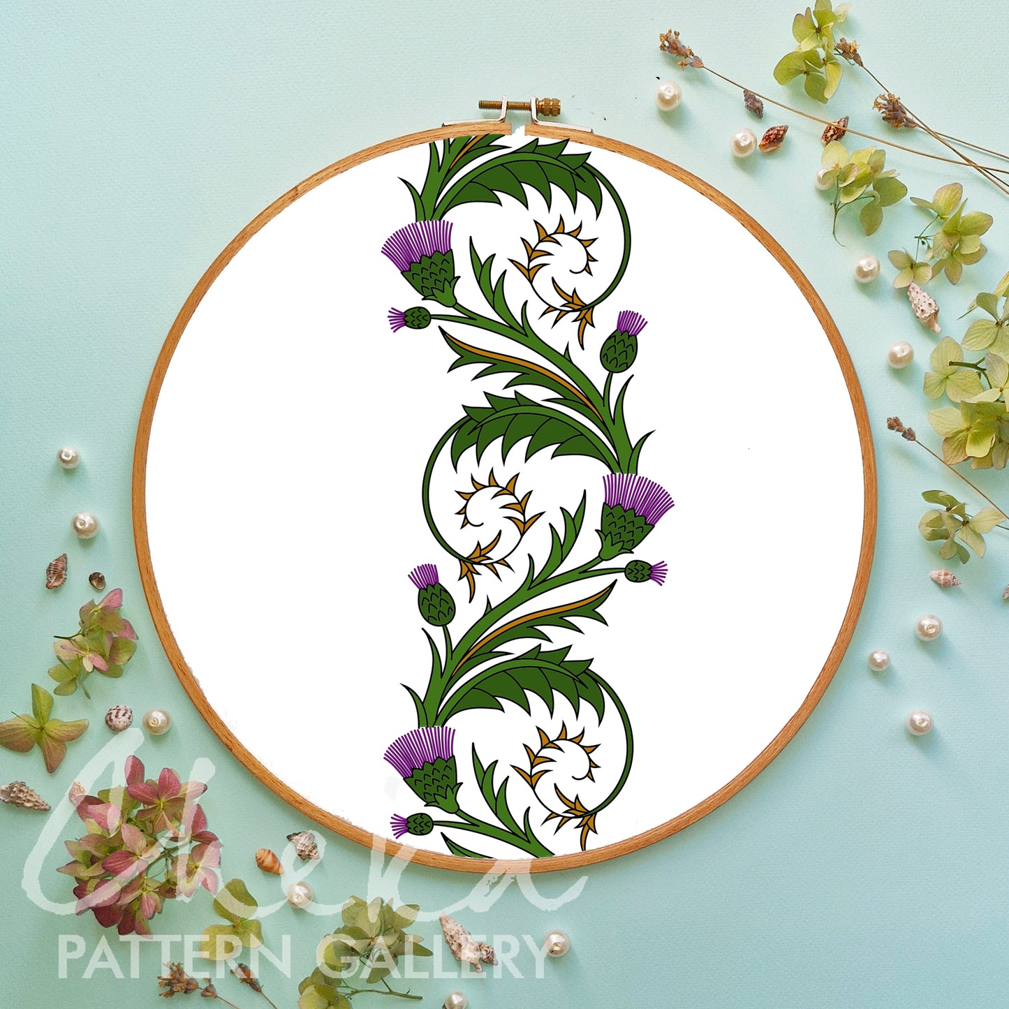 Embroidery hoop with floral design on a light blue background
