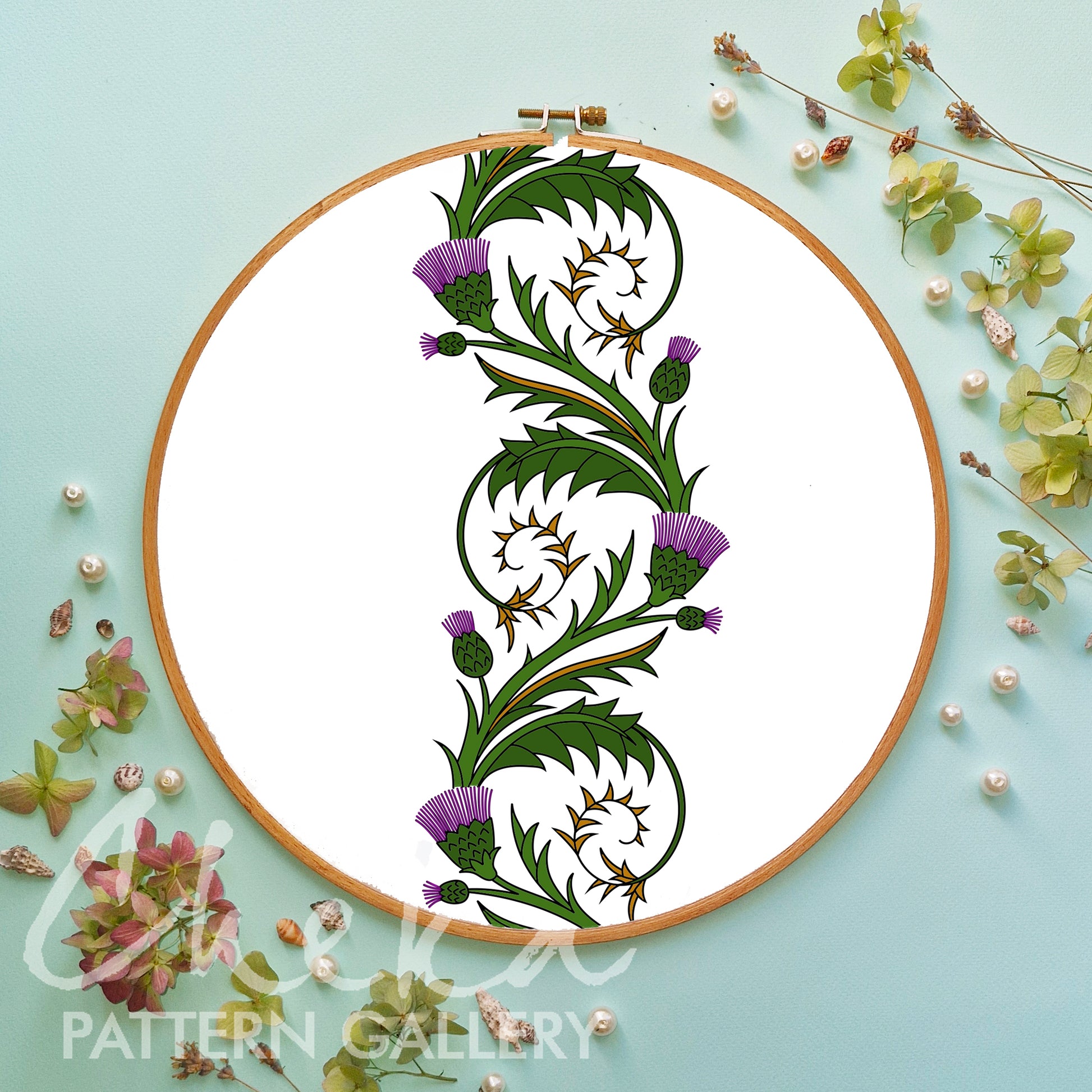 Embroidery hoop with floral design on a light blue background