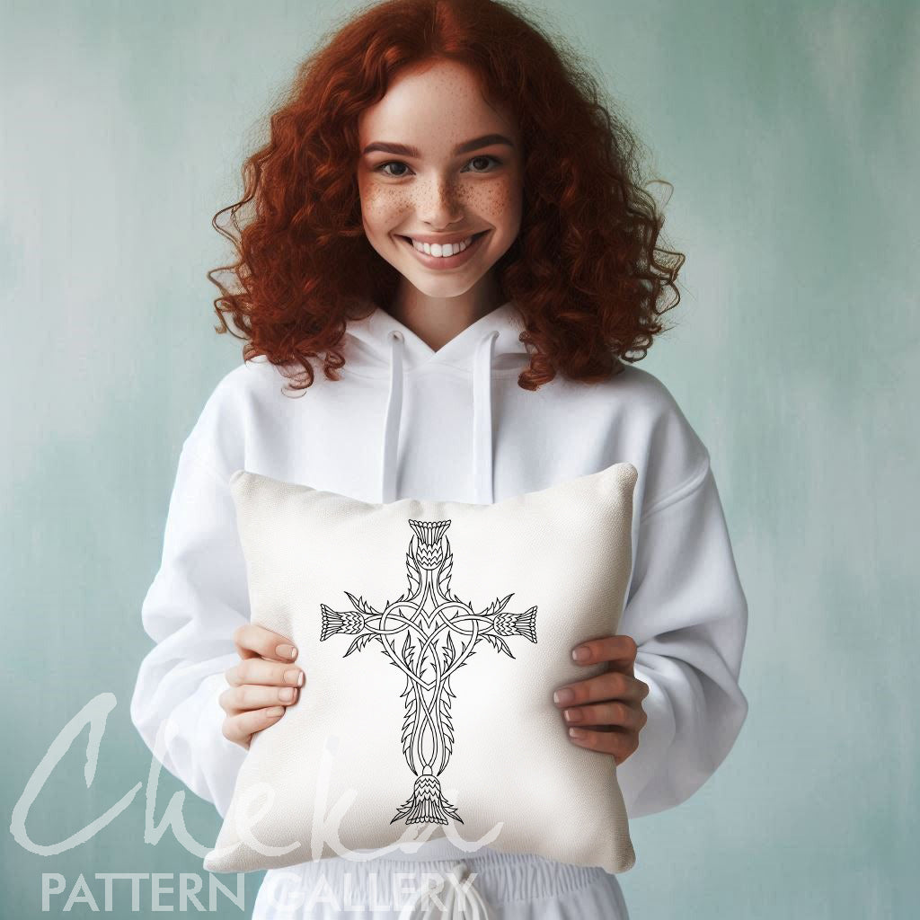 Woman holding a pillow with a Celtic cross design against a light background